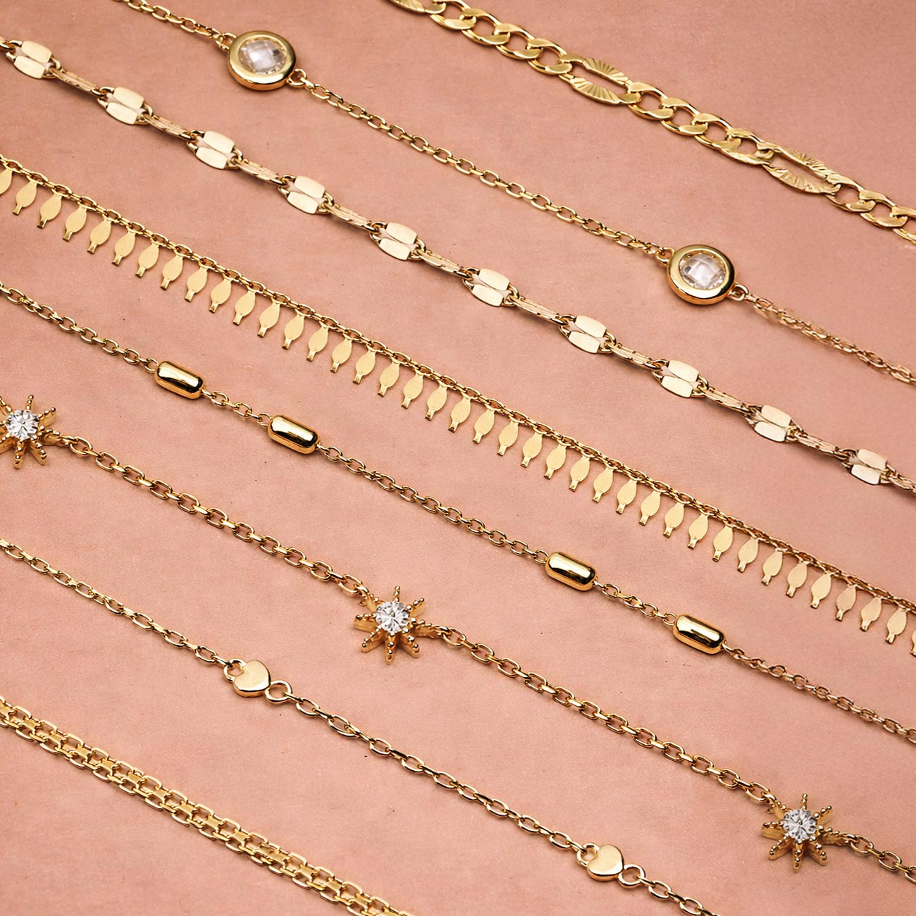 AMYO gold necklaces featuring layered chains, star accents and charm details, styled flat lay for everyday wear, layering, and gift-ready jewelry.