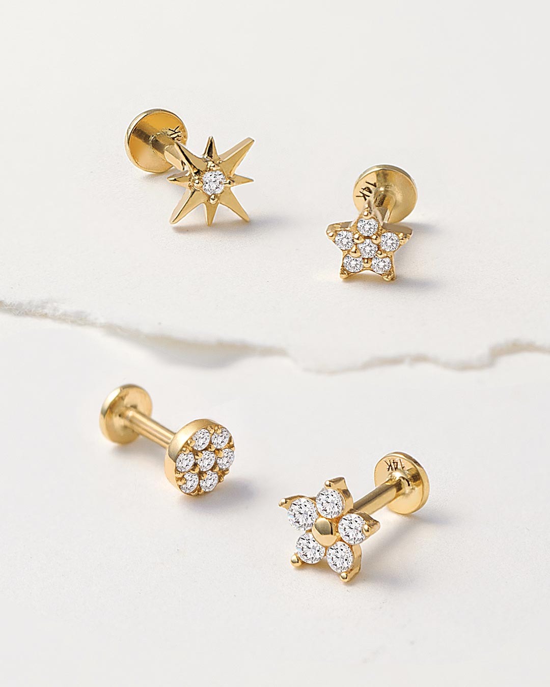 Shop AMYO 14K flat back earrings featuring starburst and floral designs, ideal for second hole piercings, cartilage piercings, and stacking stacking earrings.