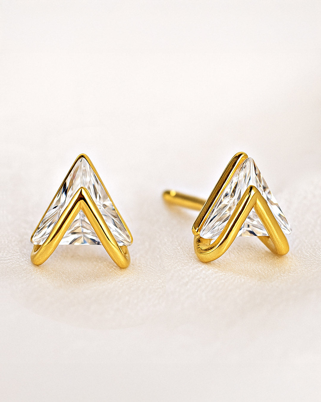 Pair of trinity stud earrings on soft background – shop dainty everyday studs for gifting and stacking.