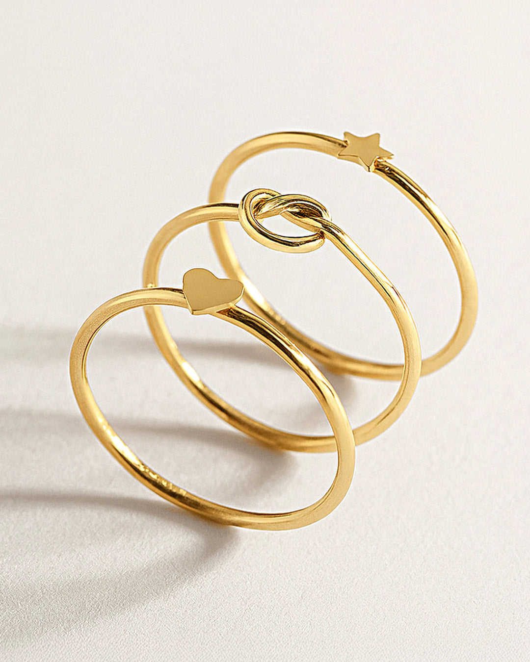 Shop AMYO dainty gold rings with heart, star, and knot designs, perfect as minimalist stacking rings and timeless everyday jewelry essentials.