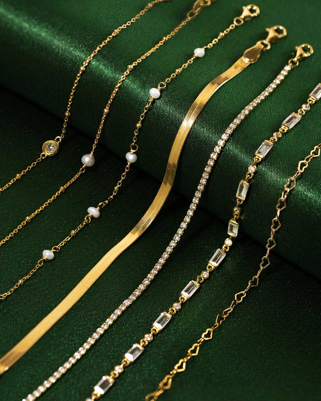 Shop AMYO gold chain bracelets featuring crystal, pearl, and herringbone styles, crafted for layering, stacking, and elegant everyday jewelry looks.