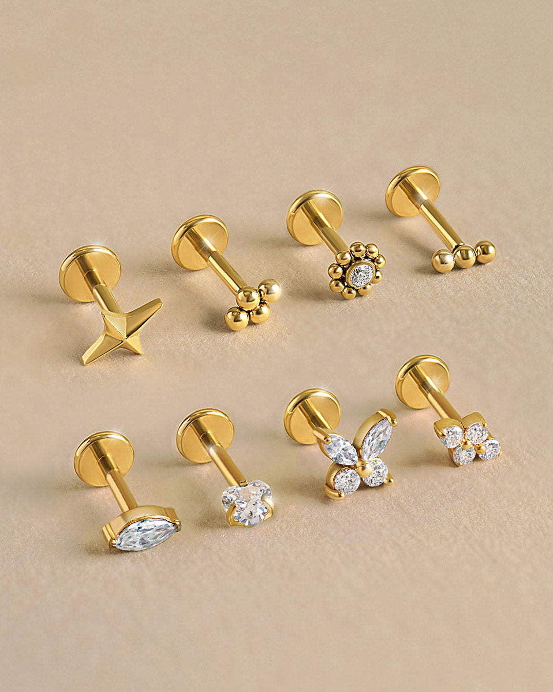 AMYO flat back earrings in gold with dainty crystal and beaded designs, crafted for cartilage and helix piercings or chic everyday minimalist jewelry.