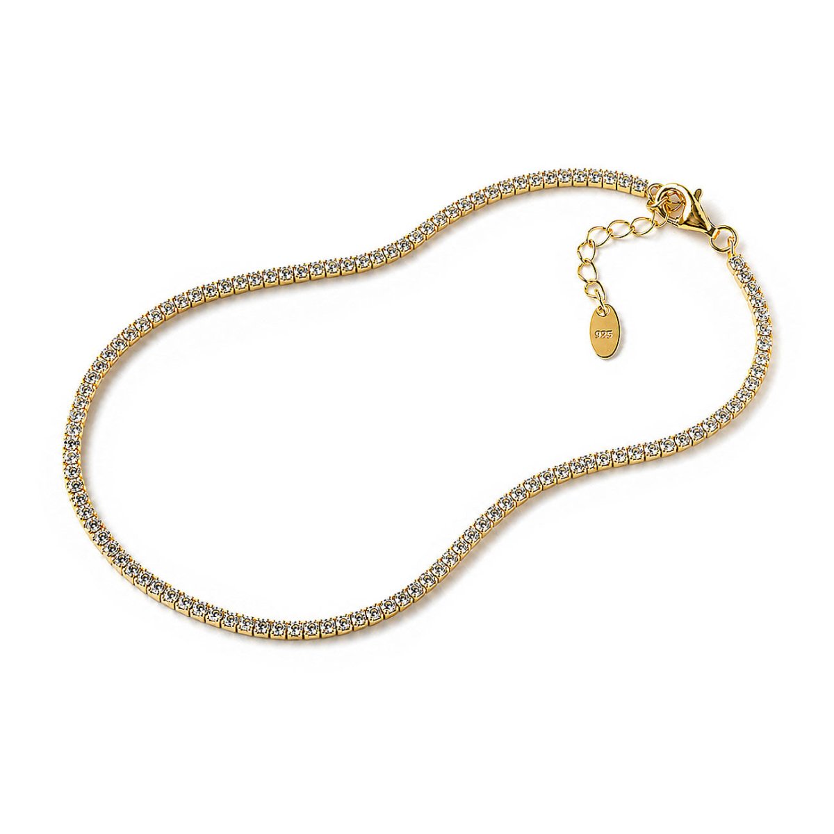 A gold tennis-style chain necklace paved with small clear stones, shown on a plain white background with a lobster clasp and extender chain.