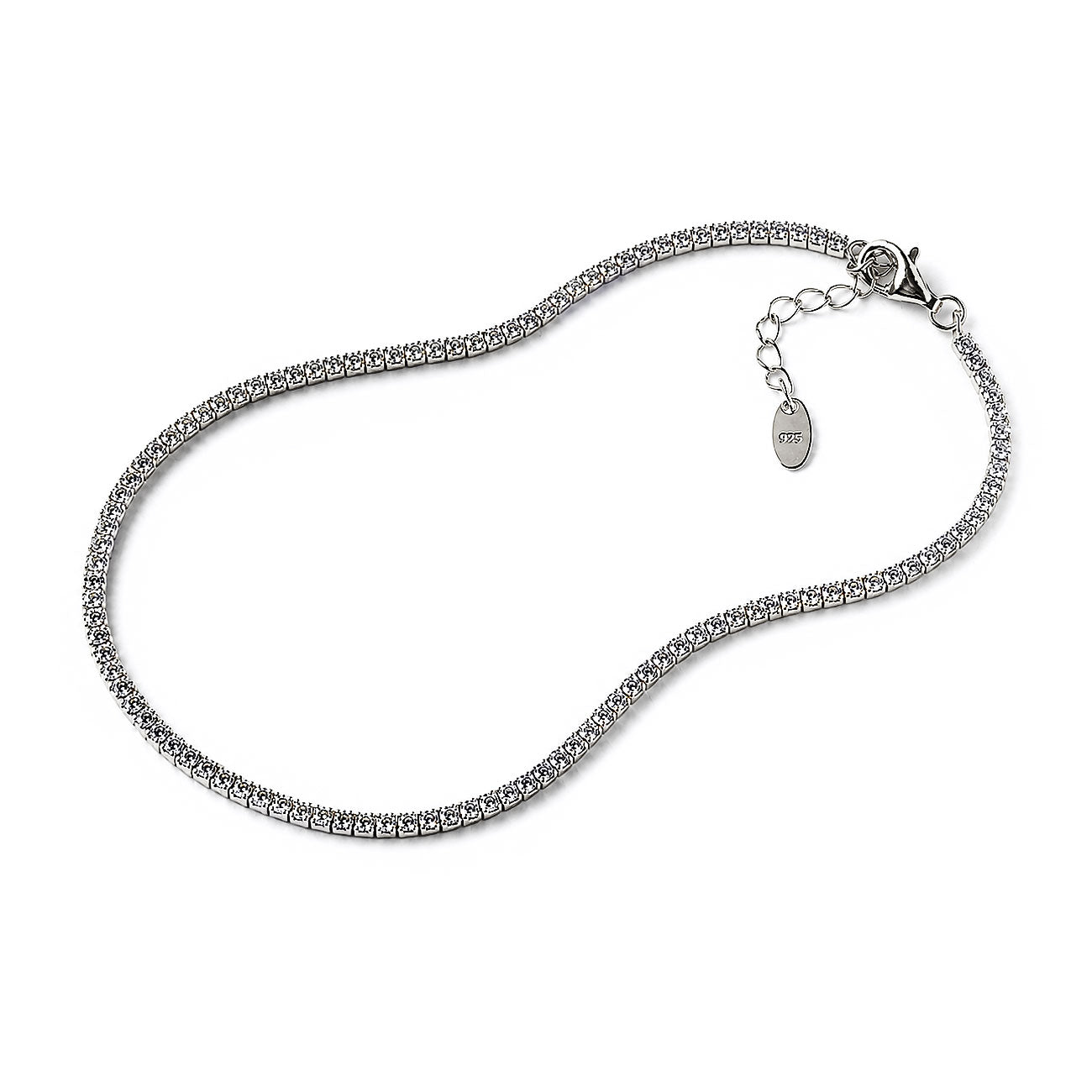 A silver tennis-style chain necklace with a lobster clasp and extender chain featuring a small oval tag, photographed on a plain white background.