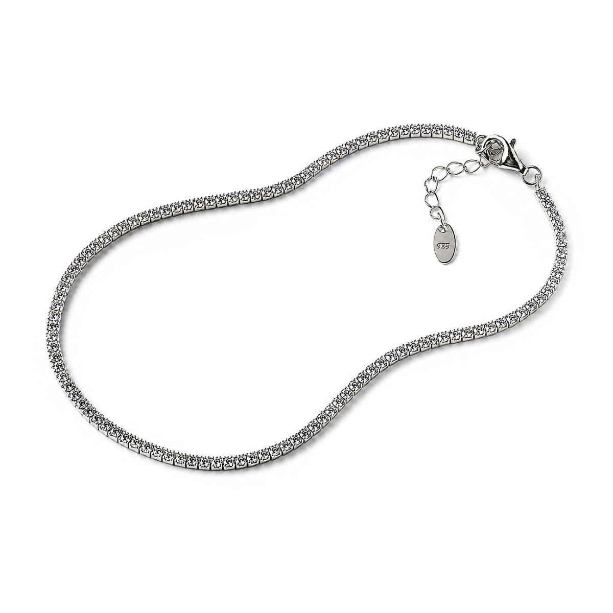 A silver tennis-style chain necklace with a lobster clasp and extender chain featuring a small oval tag, photographed on a plain white background.