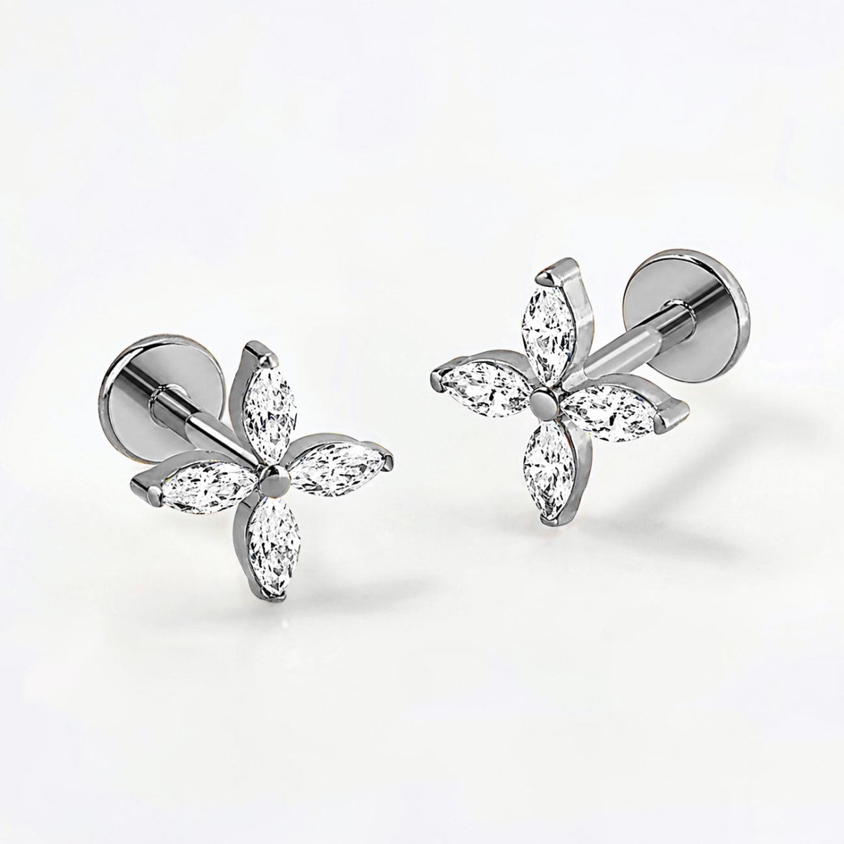 Titanium crystal fleur flat back stud earrings, on a grey background
