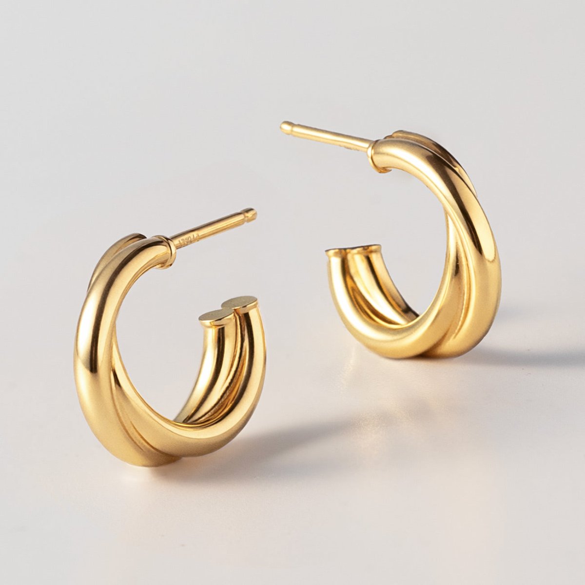 An up close detailed shot of the Gold Vermeil Criss Cross Mini Hoops from AMYO