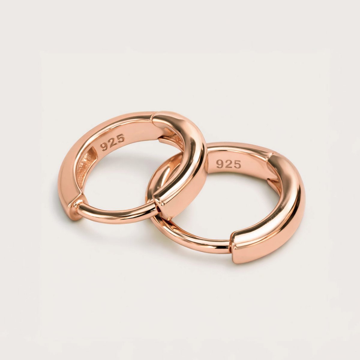 Detailed Shot of AMYO'S Huggie Hoop Earrings in Rose Gold Vermeil