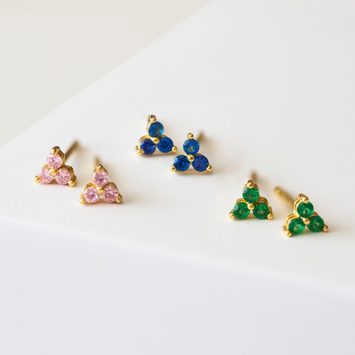 Close up of earring featuring 14K Gold Gemstone Clover Studs Pink CZ Crystals and other gemstone colors