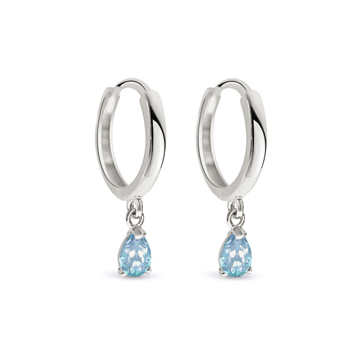 Pair of 14K white gold huggie hoops with pear-cut aquamarine drops, on a white background