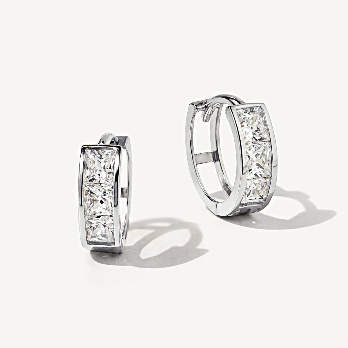 Detailed shot of 14K White Gold Princess Cut Huggie Hoops in White Zirconia from AMYO