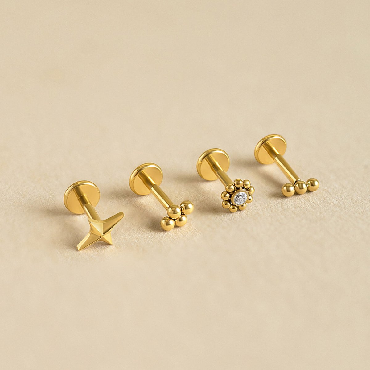 AMYO flat back earrings in gold with dainty star and beaded designs, crafted for cartilage and helix piercings or chic everyday minimalist jewelry.
