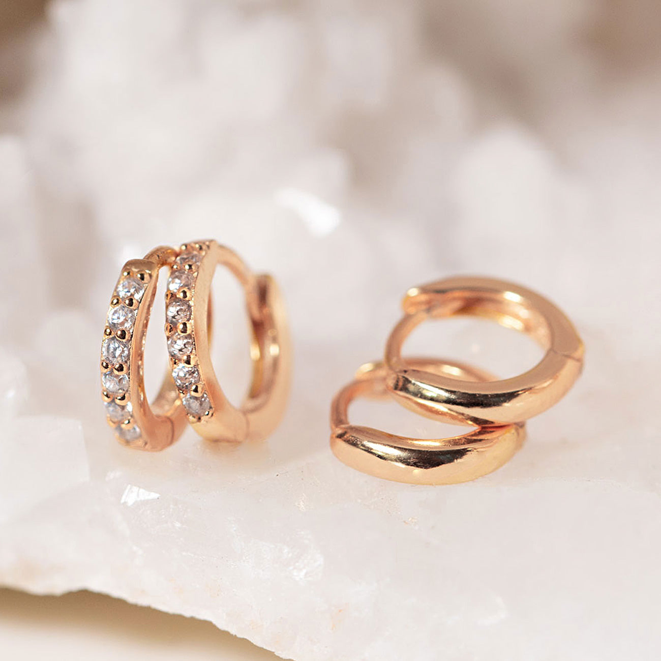 AMYO Rose gold rings with gemstones on a shell background