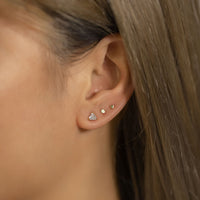 Tiny Gold circle and triangle studs on second and third piercing with Triangle CZ Stud Earring