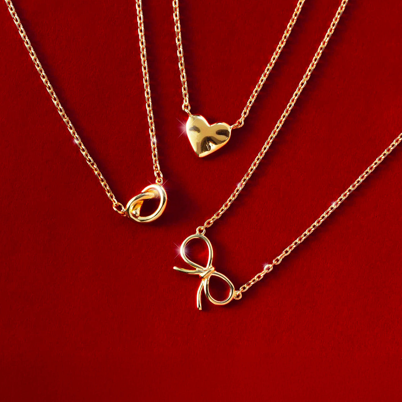 AMYO’s gold necklaces featuring heart, bow, and knot accents, designed as meaningful jewelry gifts perfect for birthdays, holidays, and everyday gifting.
