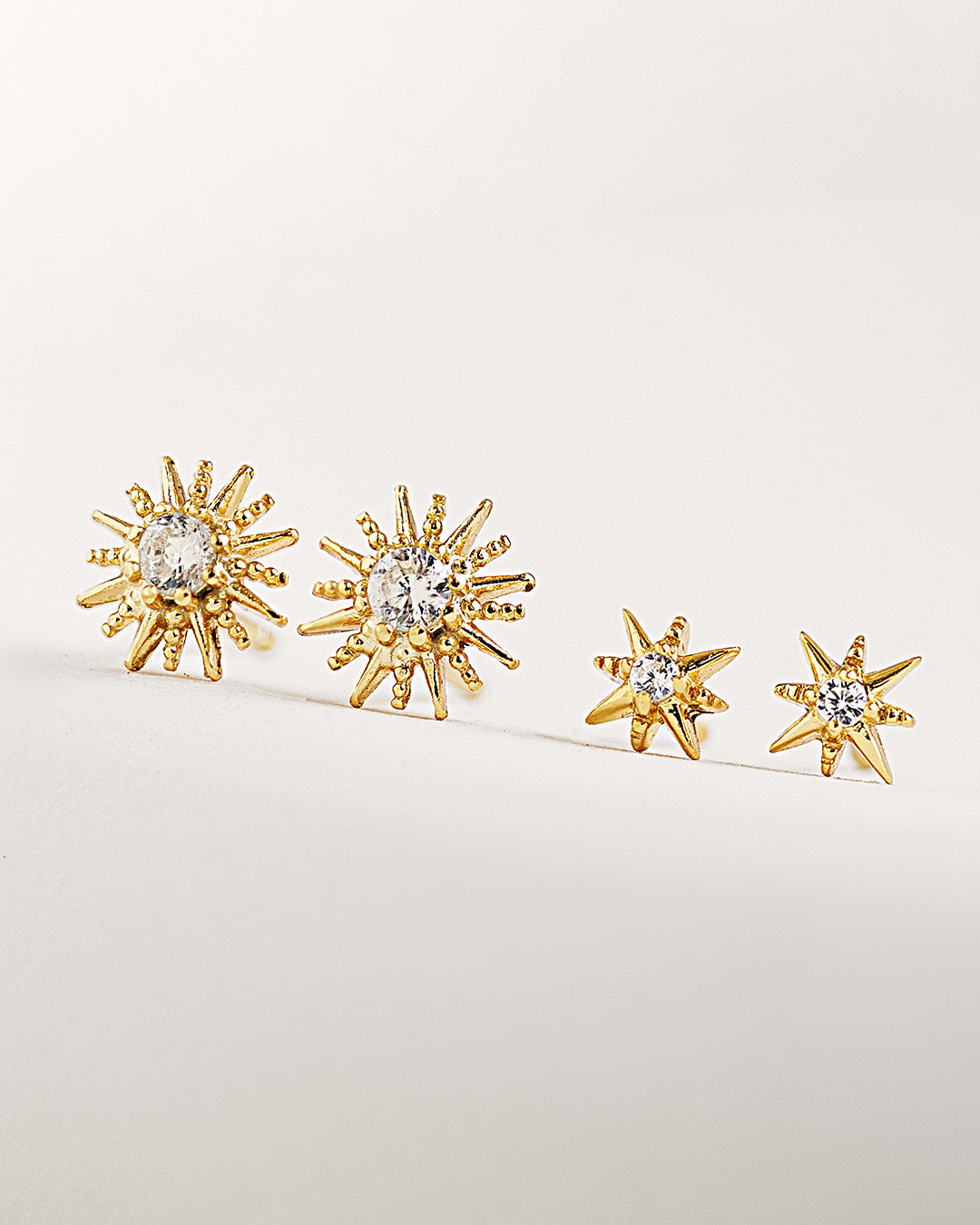 Shop AMYO dainty gold stud earrings featuring starburst designs, ideal for second hole piercings, stacking earrings, and everyday jewelry looks.