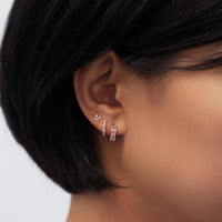 Close-up of woman's ear featuring Amyo Jewelry's Gold Vermeil Gemstone Earrings Pink Collection