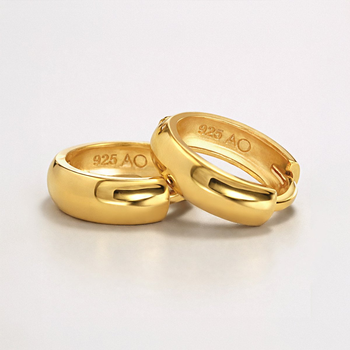 Detailed shot of AMYO's Boyfriend huggies in gold vermeil