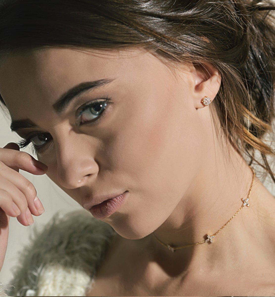 Headshot of woman featuring 14K Gold White Sapphire Studs