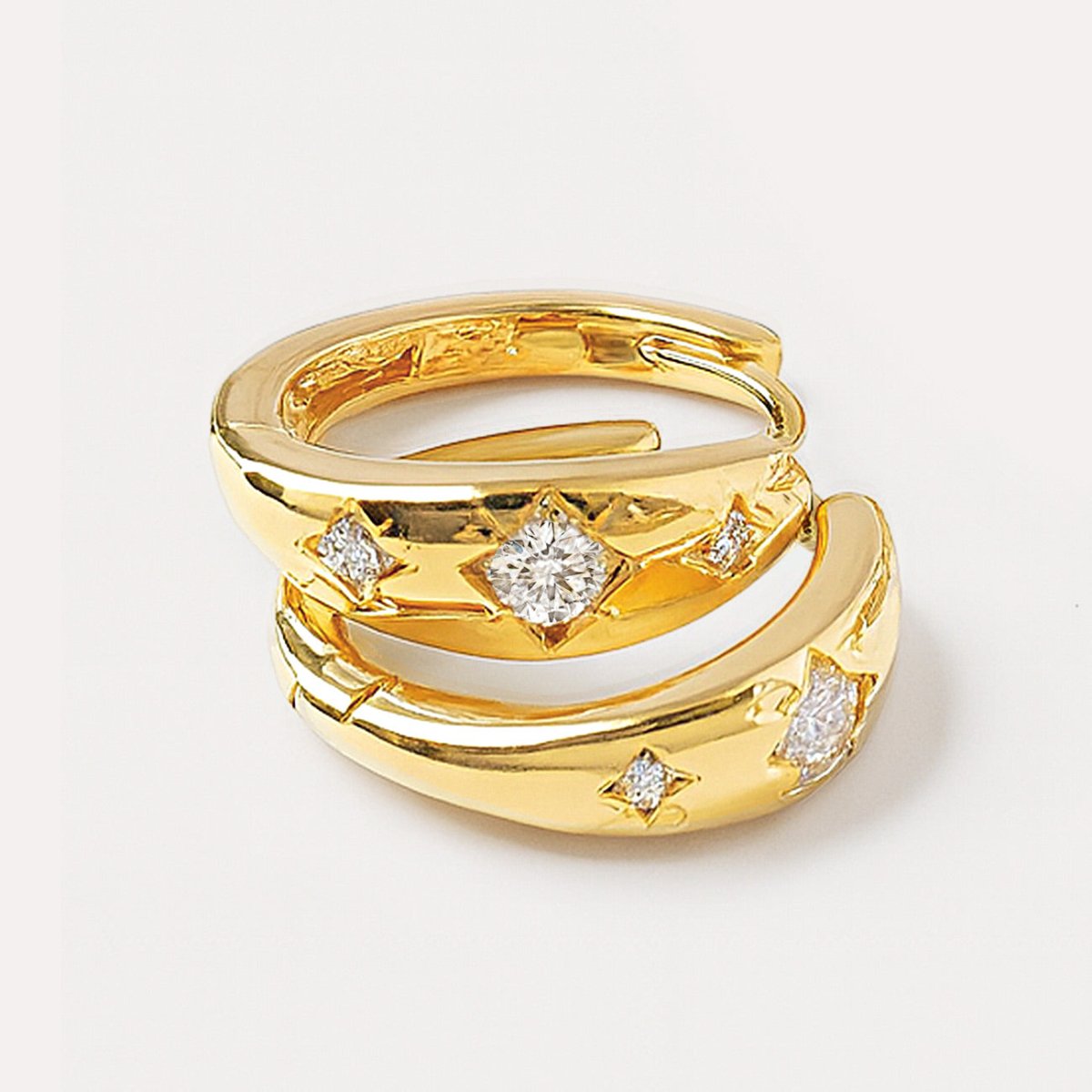 Detailed shot of Celestial Mini Hoops with beige background