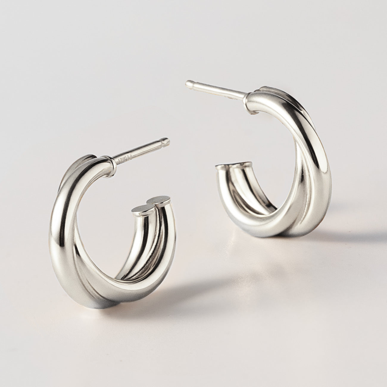 A detailed shot of the Criss Cross Mini Hoops from AMYO in Sterling Silver