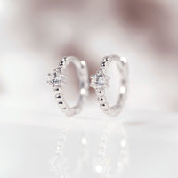 Close-up on earring featuring Sterling Silver Pave Bead Huggie Earrings CZ Crystals