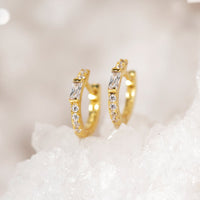 Close-up on earring featuring Gold Vermeil Baguette Huggie Earrings CZ Crystal