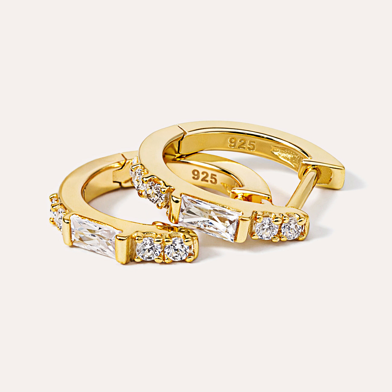 Close-up shot of AMYO's Gold Vermeil Baguette Huggie Earrings with Cubic Zirconia Crystals