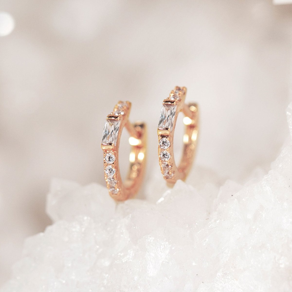 Close-up on earring featuring Rose Gold Baguette Huggie Earrings CZ Crystal 