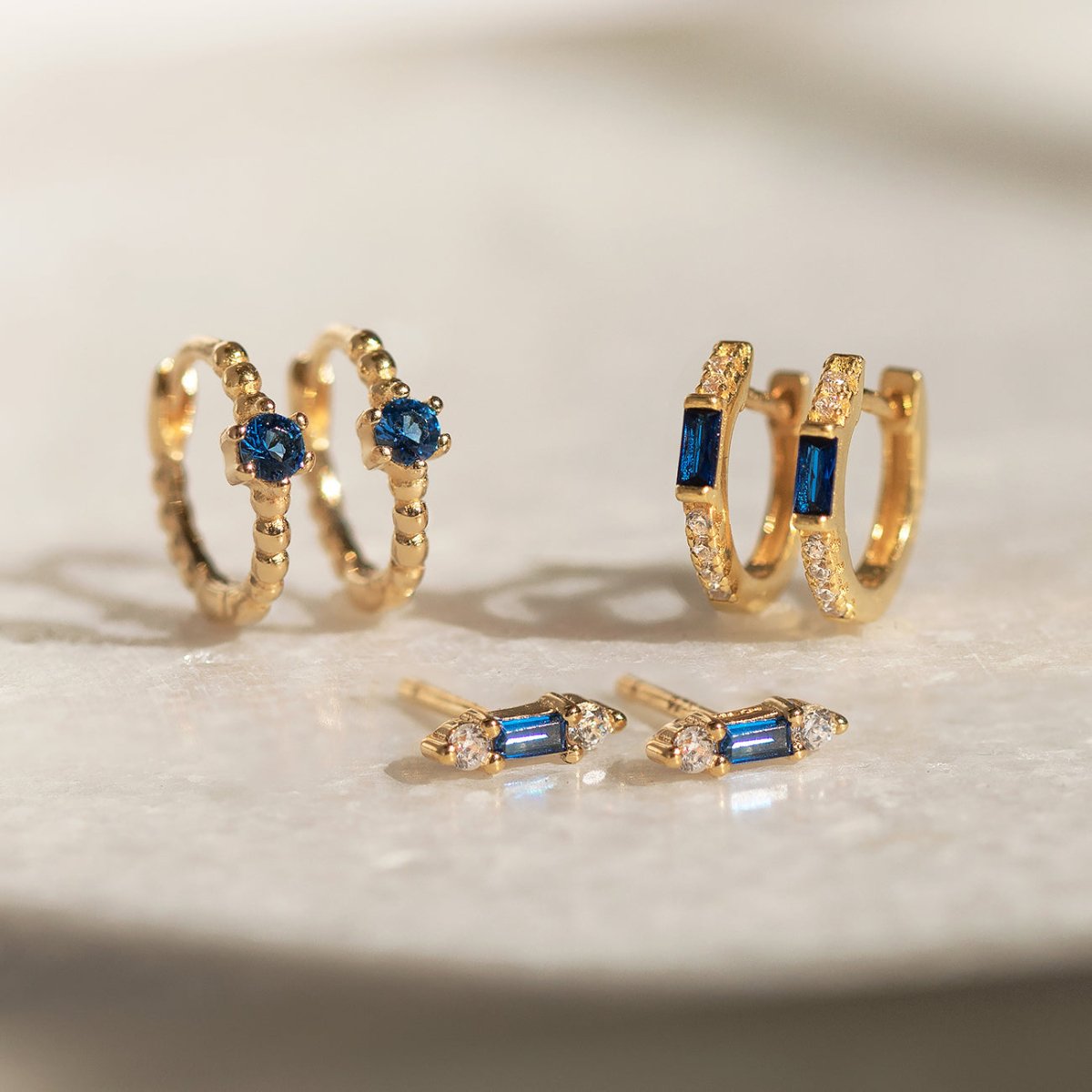 Close-up of earrings featuring Gold Vermeil Gemstone Blue Sapphire collection. 