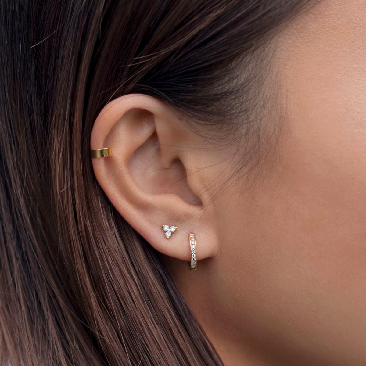 Close up of woman's ear featuring Gold Vermeil Tiny Clover Pave Studs and rose gold hoop earring 