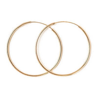 Close-up of earrings featuring 14K Solid Gold Thin Midi Hoops