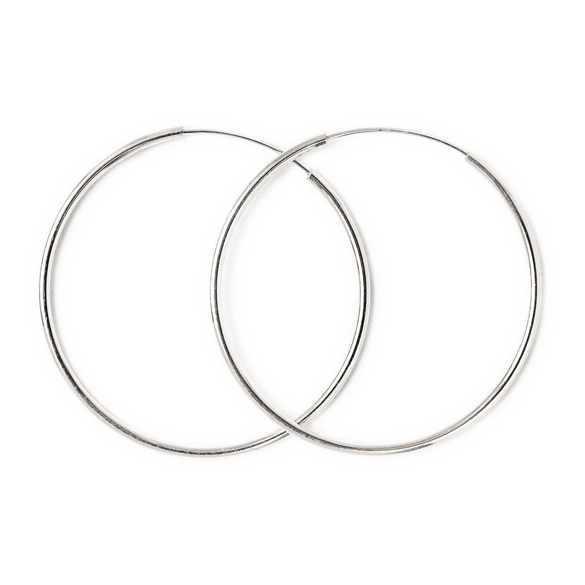 Close-up of earrings featuring 14K White Gold Thin Midi Hoops