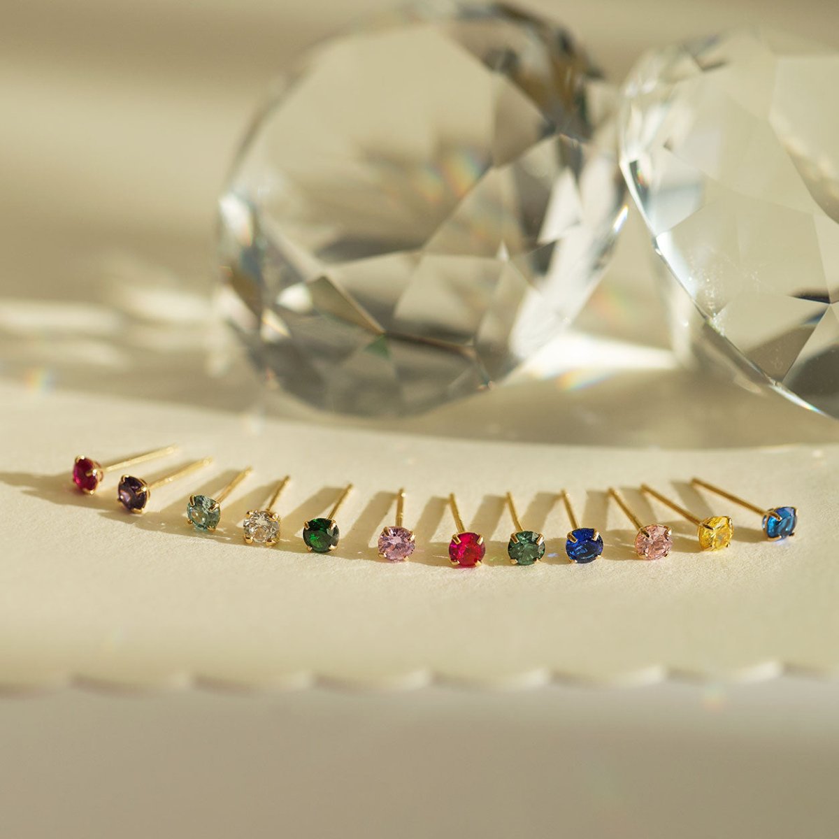 Close-up of earring display of 14K Gold Birthstone Tiny Studs 