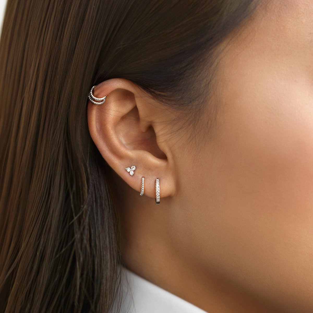 Model wearing the Pavé and Rope Huggies Set, Clover Pavé stud with rope ear cuff on the helix in sterling silver from AMYO
