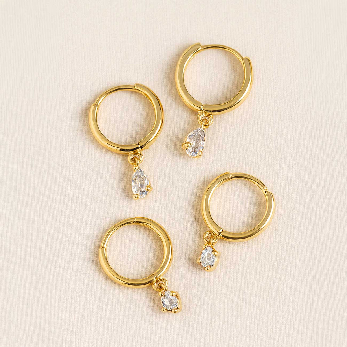 14K gold pear drop moissanite huggie hoops, close-up detail