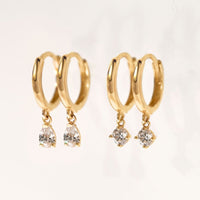 Close-up of earrings featuring 2 Different 14K Gold Gemstone Dangle Huggies Moissanite 