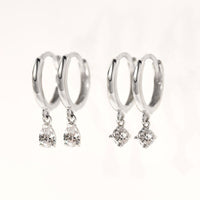 Close-up of earrings featuring 2 different 14K White Gold Pavé Dangle Huggie Earrings