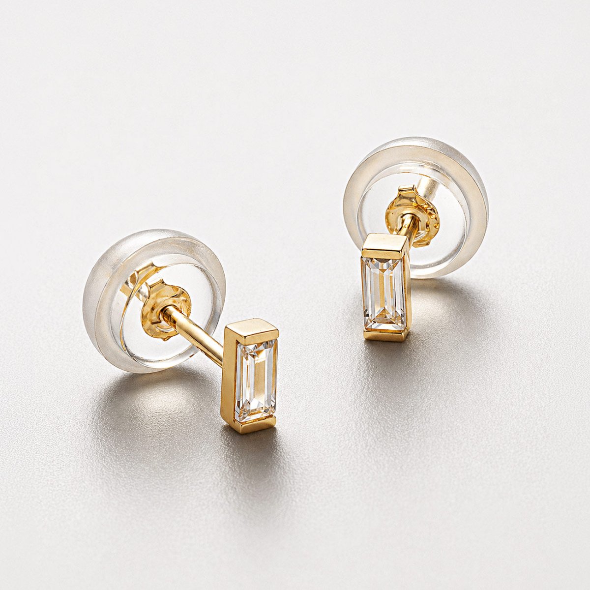 14K Gold Tiny Baguette Stud Earrings wtih White Zirconia crystals. Comes with Silicone Backs, perfect for second, third piercings from AMYO.