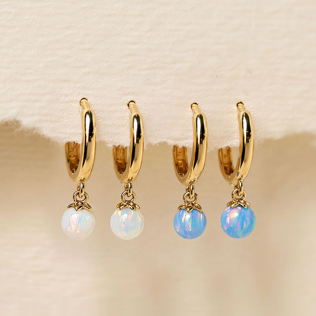 Dangling 14K Gold Tiny Opal Huggies  with Blue Opal and White Opal from AMYO