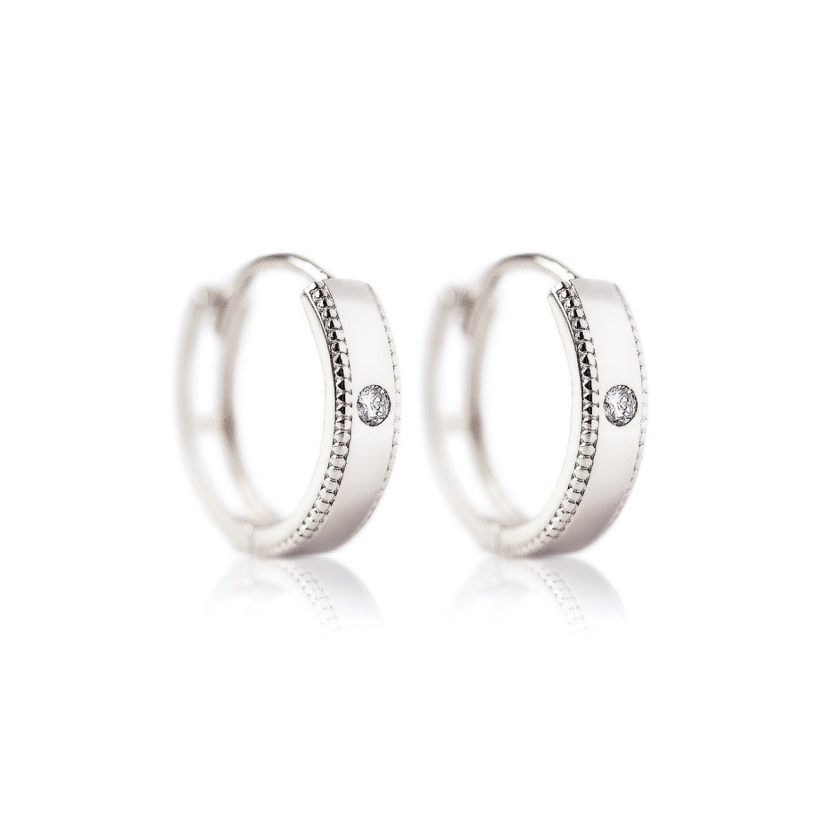 Pair of sterling silver milgrain huggie hoops with a round zirconia, on a white background