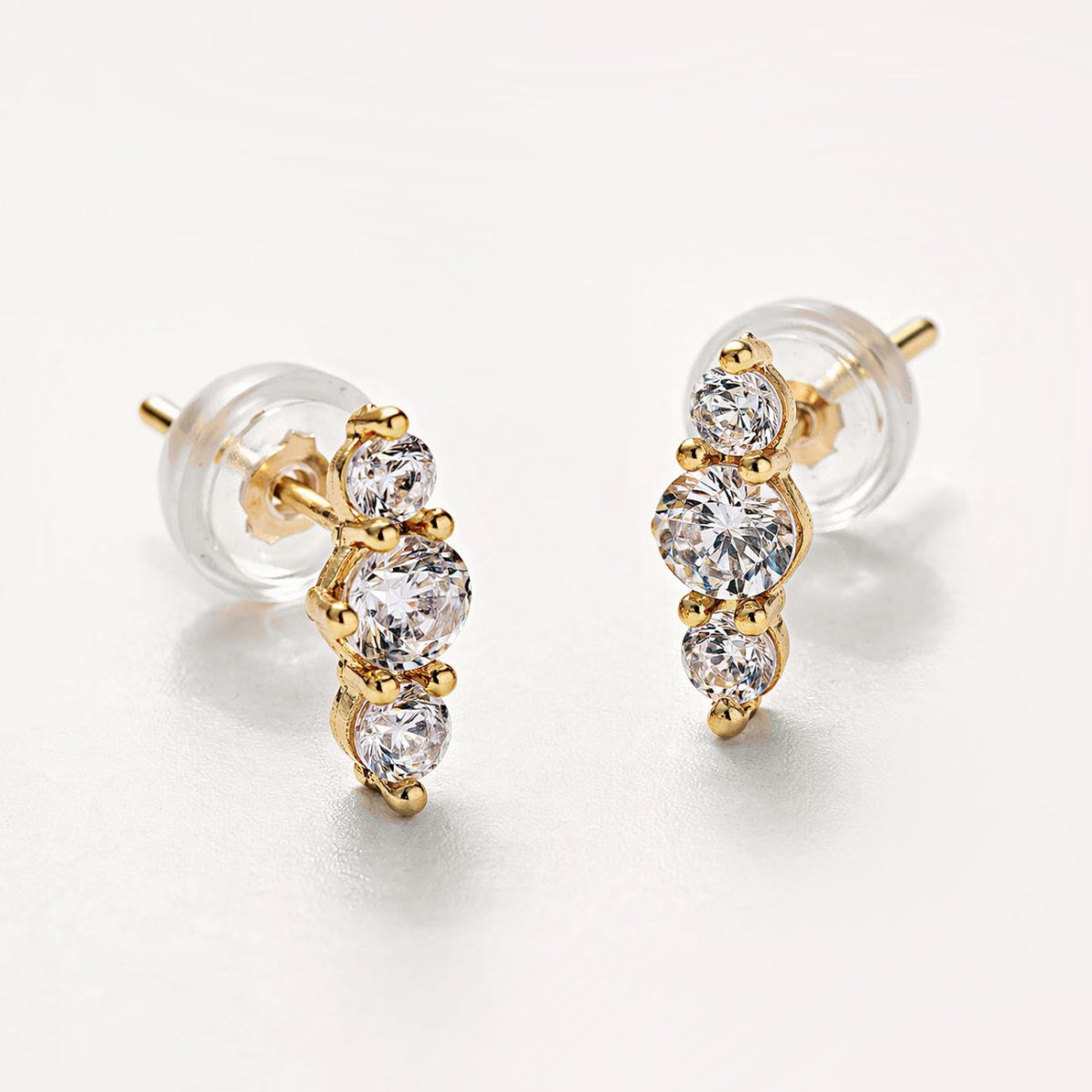 Bestselling 14K Gold Trio Bar Pavé Studs from AMYO with silicone earring backs.