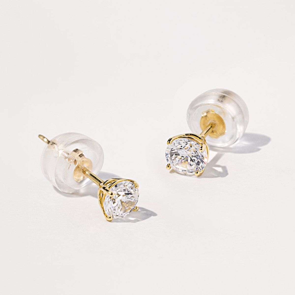 Bestselling 14K Gold White Sapphire Stud Earrings with silicone backs from AMYO