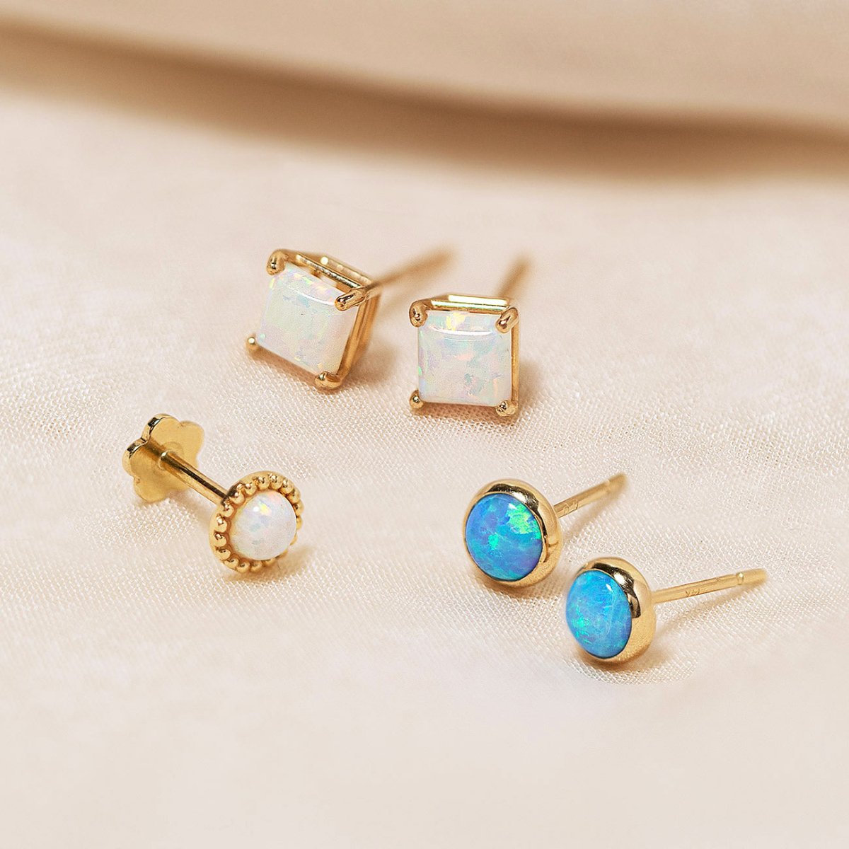 14K Gold Opal Stud Earrings from AMYO featuring blue and white opals.