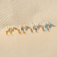 Close-up of earrings featuring 14K White Gold Opal Huggies 