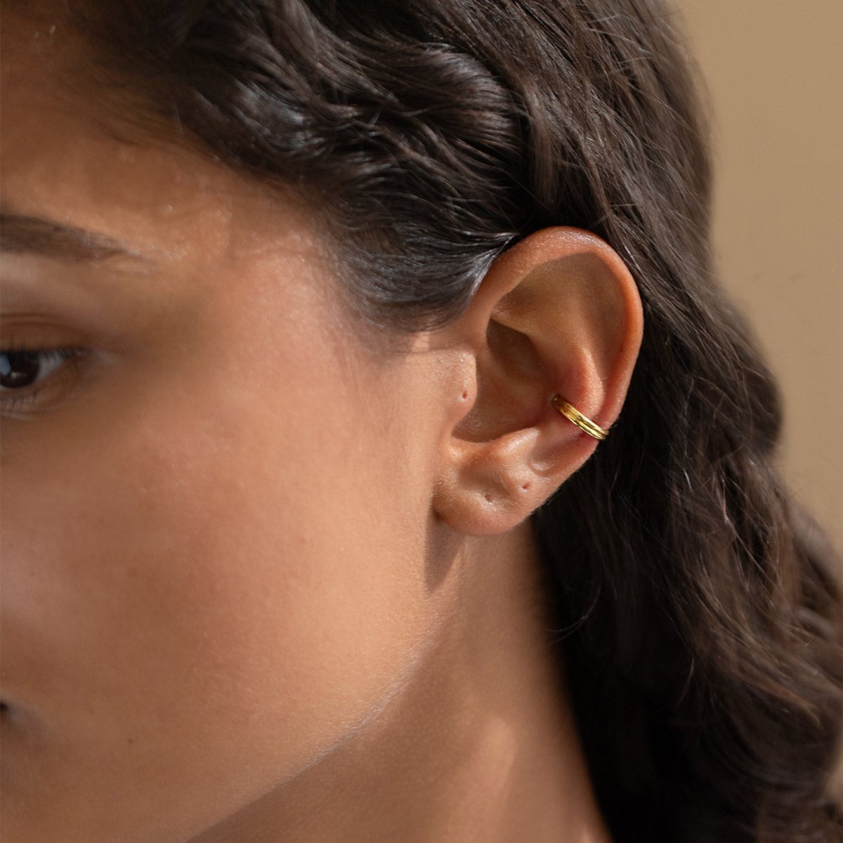 caption: Model wearing 10mm on conch
