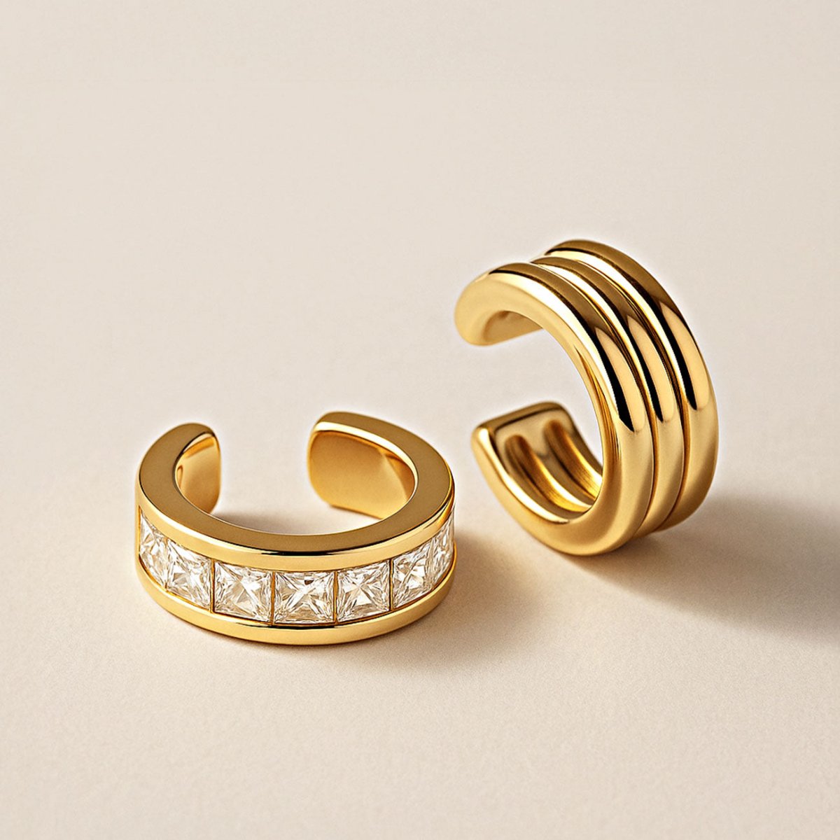 Bold Gold ear cuffs on a beige background from AMYO. 