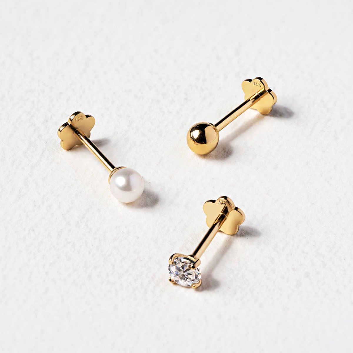 Detailed shot of 14K Gold flat back earrings featuring sphere, pearl and crystal accents from AMYO