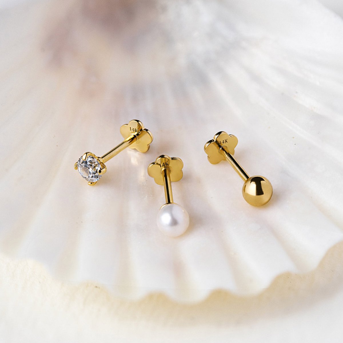 14K Gold flat back earrings with a pearl, clear crystal and round sphere on a shell background from AMYO