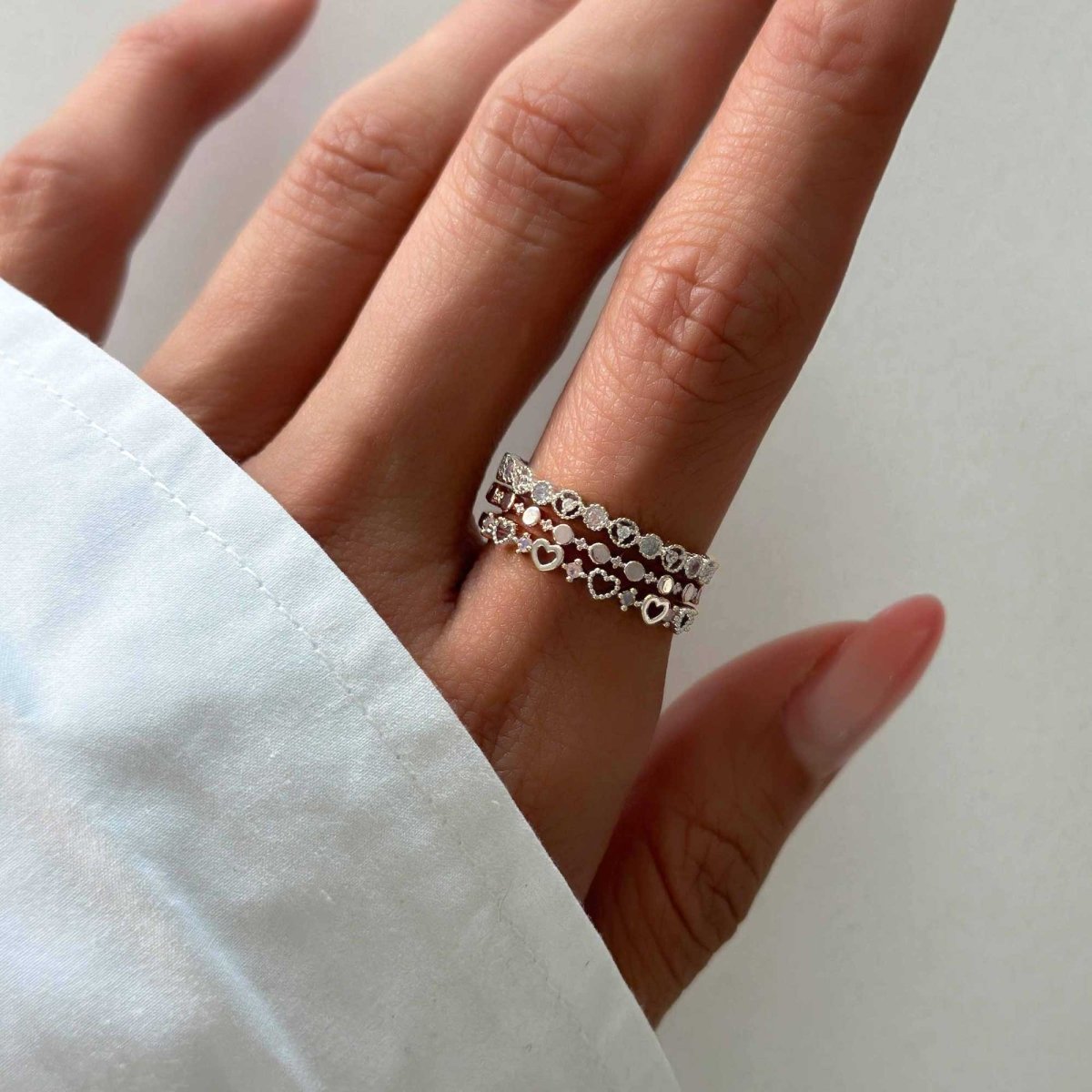 Sterling silver eternity stacking rings shown stacked on a model's hand